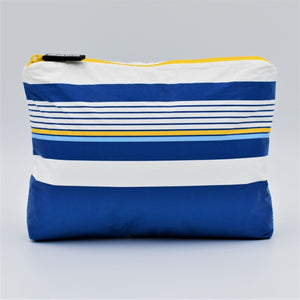 Small zip pouch in Lined Up pattern in blue, white and golden yellow.