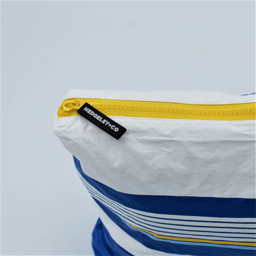 Zip detail of Large zip pouch in Lined Up pattern in blue, white and golden yellow.