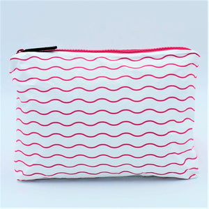 Small zip pouch in Waving pattern in hot pink and white.