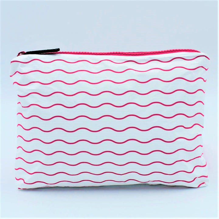 Small zip pouch in Waving pattern in hot pink and white.