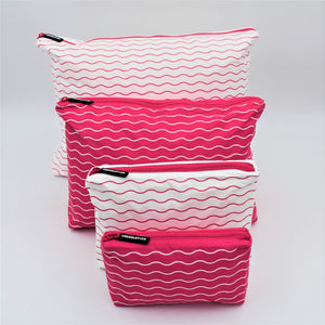 Big bundle of four zip pouches in Mini, Small, Medium and Large. Waving pattern in hot pink and white.