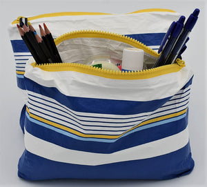 Small zip pouch in Lined Up pattern in blue, white and golden yellow.