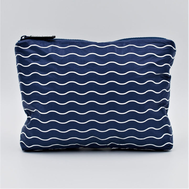 Small zip pouch in Waving pattern in navy blue and white.