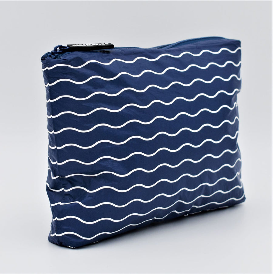 Small zip pouch in Waving pattern in navy blue and white.