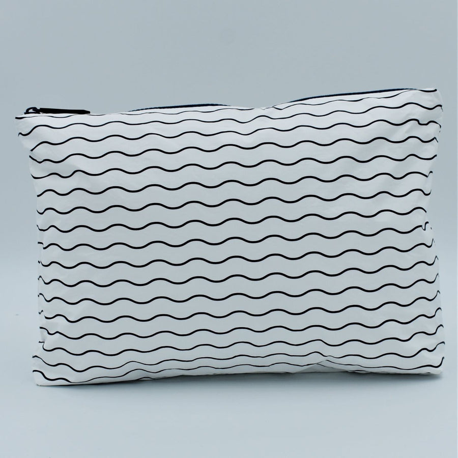 Medium zip pouch in Waving pattern in navy blue and white.