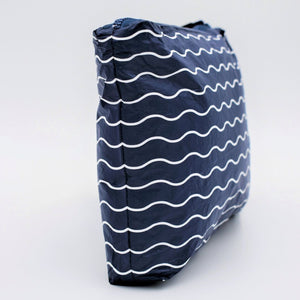 Side view of Large zip pouch in Waving pattern in navy blue and white.