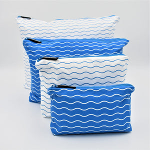 Big bundle of four zip pouches in Mini, Small, Medium and Large. Waving pattern in summer blue and white.