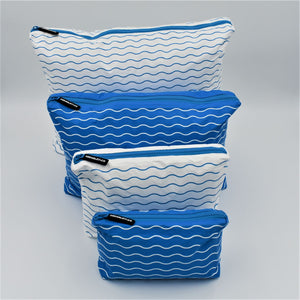 Big bundle of four zip pouches in Mini, Small, Medium and Large. Waving pattern in summer blue and white.