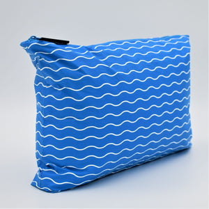 Side view of Medium zip pouch in Waving pattern in summer blue and white.