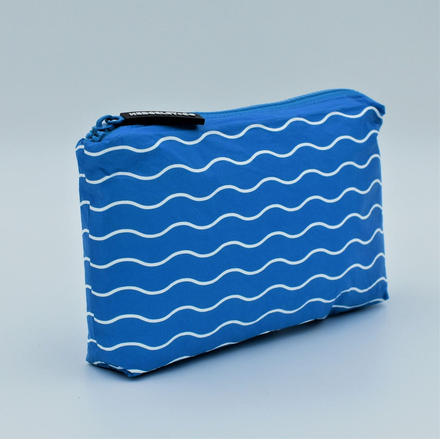 Side view of Mini zip pouch in Waving pattern in summer blue and white.