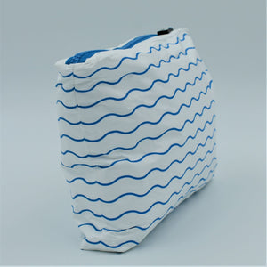 Side view of Small zip pouch in Waving pattern in summer blue and white.