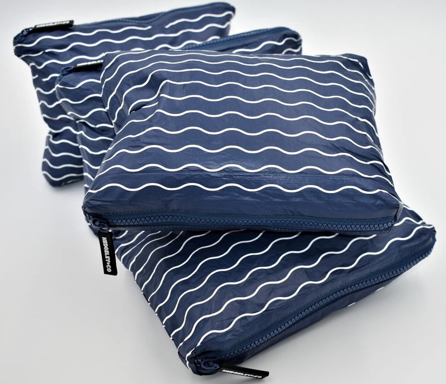 Small zip pouch in Waving pattern in navy blue and white.