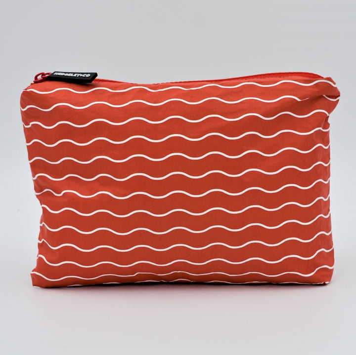 Small zip pouch in Waving pattern in tomato red and white.