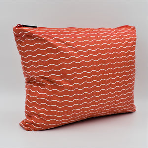 Side view of Large zip pouch in Waving pattern in tomato red and white.