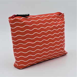 Side view of Small zip pouch in Waving pattern in tomato red and white.