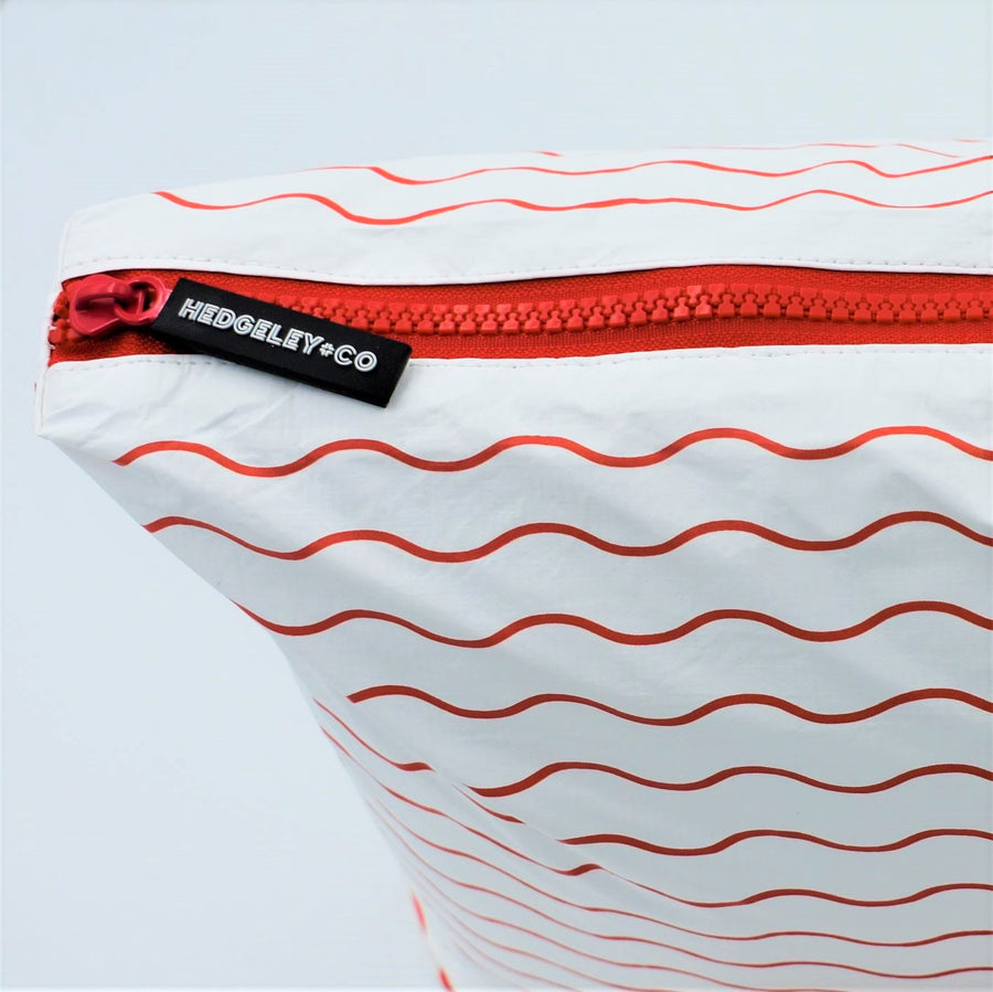 Zip view of Mini zip pouch in Waving pattern in tomato red and white.