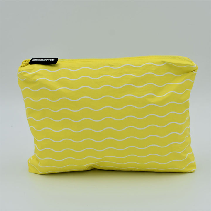 Small zip pouch in Waving pattern in yellow and white.