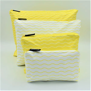 Big bundle of four zip pouches in Mini, Small, Medium and Large. Waving pattern in yellow and white.