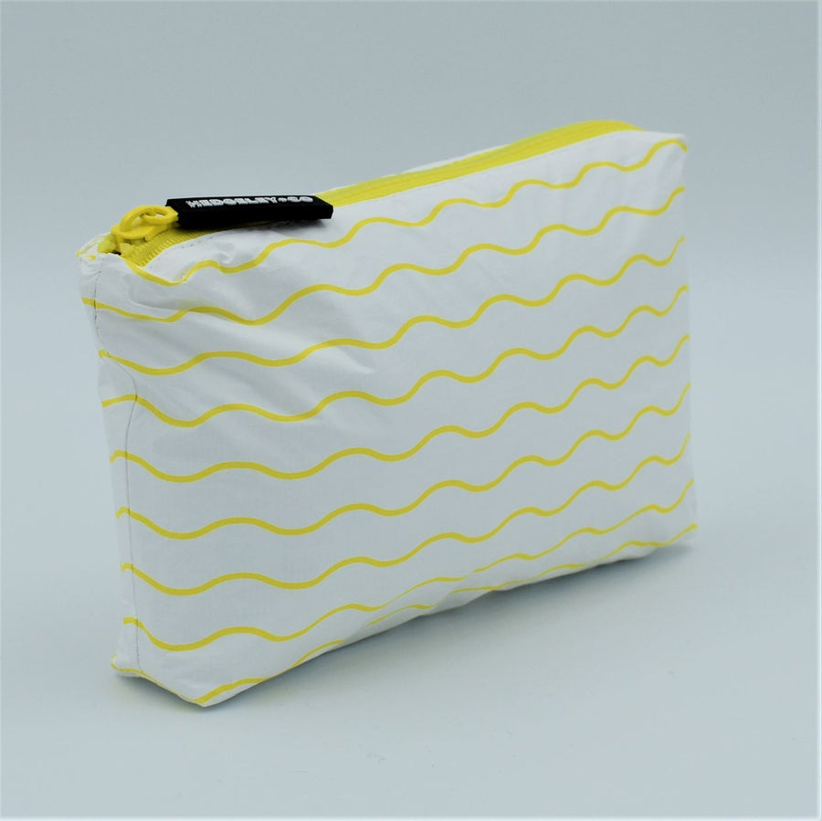 Side view of Mini zip pouch in Waving pattern in yellow and white.