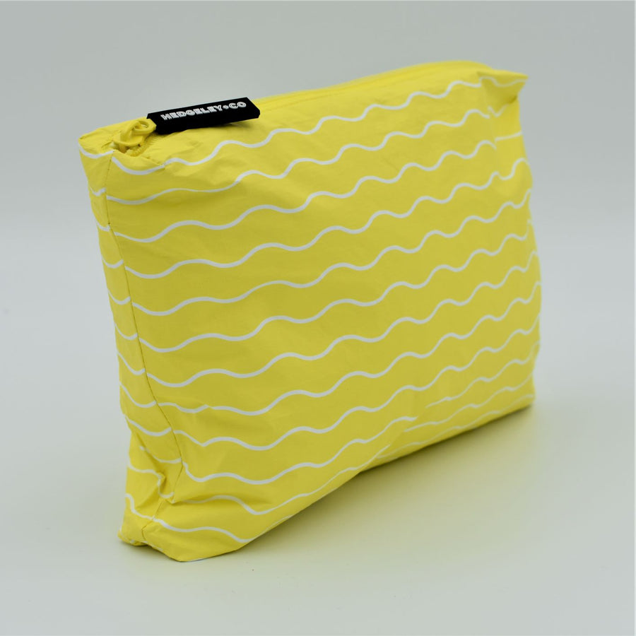 Side view of Small zip pouch in Waving pattern in yellow and white.