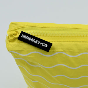 Zip detail of Large zip pouch in Waving pattern in yellow and white.